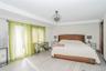 Bedroom with wood finished floors and baseboards