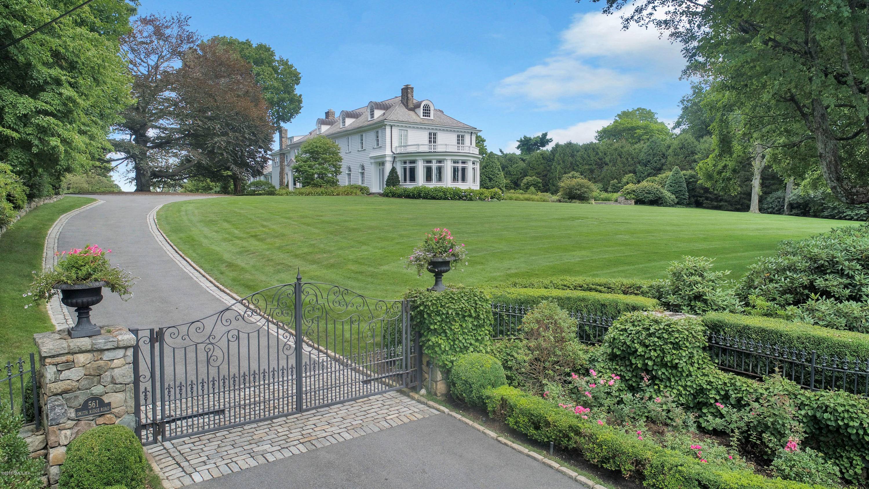 Iconic Stanford White country estate on a four acre setting perched on the highest elevation in New Canaan.
