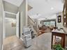 View from the entry foyer thru to the living room and basement entrance to the left. Chairlift only recently installed; can be removed if buyer prefer