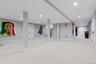 Finished below grade area featuring light carpet, recessed lighting, and stairs