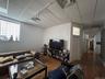 Living room with wood finished floors and a paneled ceiling