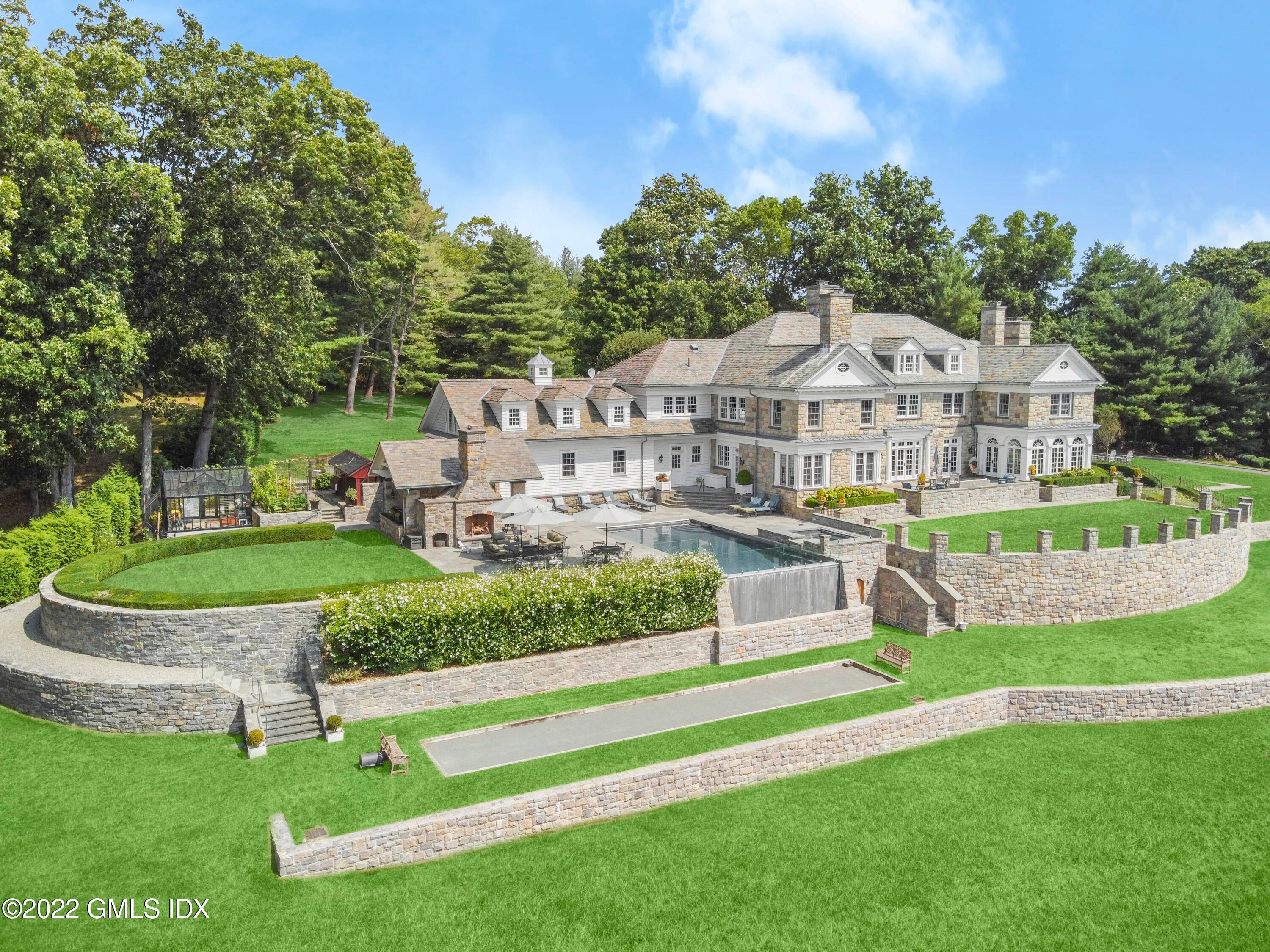 Truly unique Georgian Manor perched high atop 4 acres in the coveted Round Hill back country with an eastern exposure.