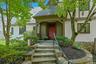 Beautiful stone steps, modern lighting, a wrought iron railing and lush plantings welcome you to this luxurious home, nestled in the heart of Edgemont