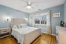 Bedroom 8 with light wood-style floors and ceiling fan