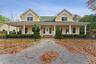 Farmhouse inspired home with stucco siding and a porch