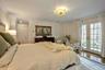 Bedroom featuring access to exterior, wood-type flooring, french doors, and ornamental molding