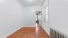 Hall with radiator heating unit and dark wood-style flooring