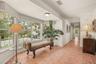 Sun-filled hallway with large windows offering peaceful views of the surrounding landscape.