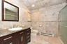 Bathroom with vanity, a baseboard heating unit, tile walls, and toilet