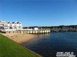 A rarely available and coveted corner unit in Greenport's most desired condominium complex with panoramic water views to Shelter Island.
