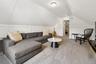 Living area with vaulted ceiling and carpet floors