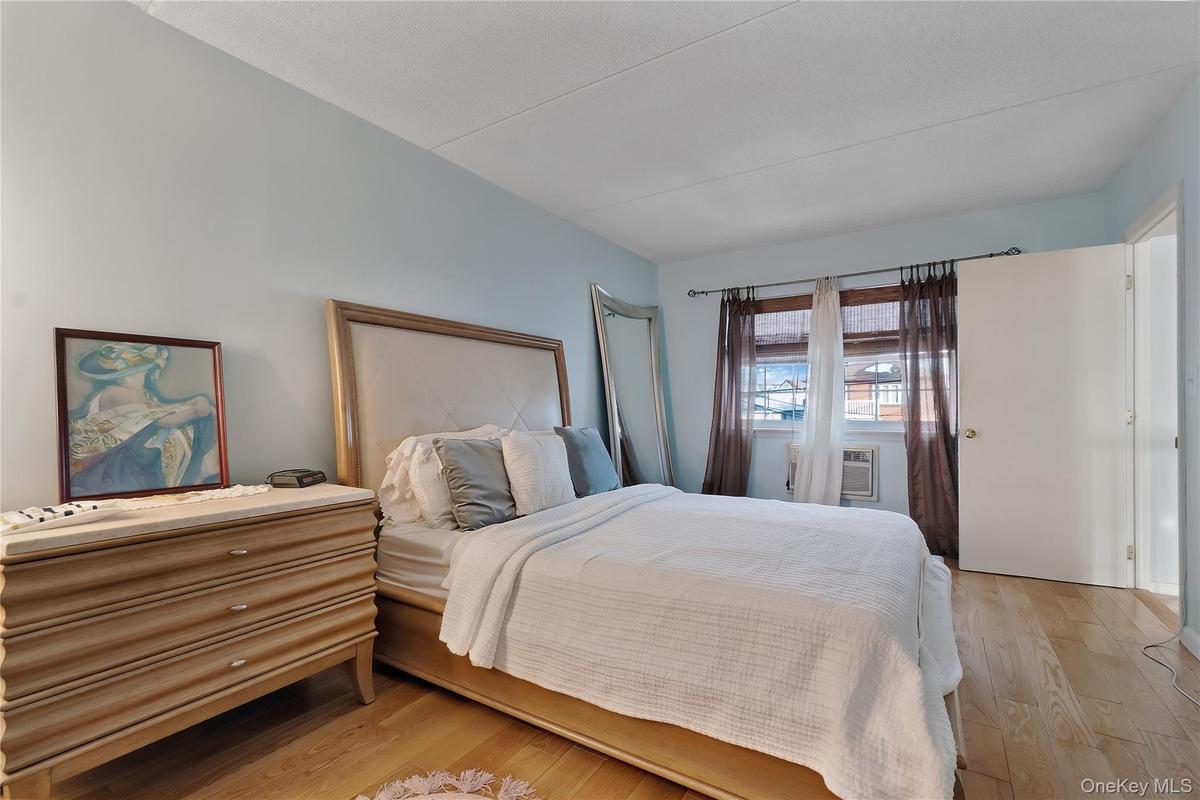 Wood-finish flooring anchors this bright room featuring light blue walls