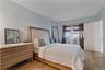 Wood-finish flooring anchors this bright room featuring light blue walls