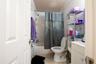 Full bathroom featuring toilet, shower / bath combo, vanity, and tile patterned floors