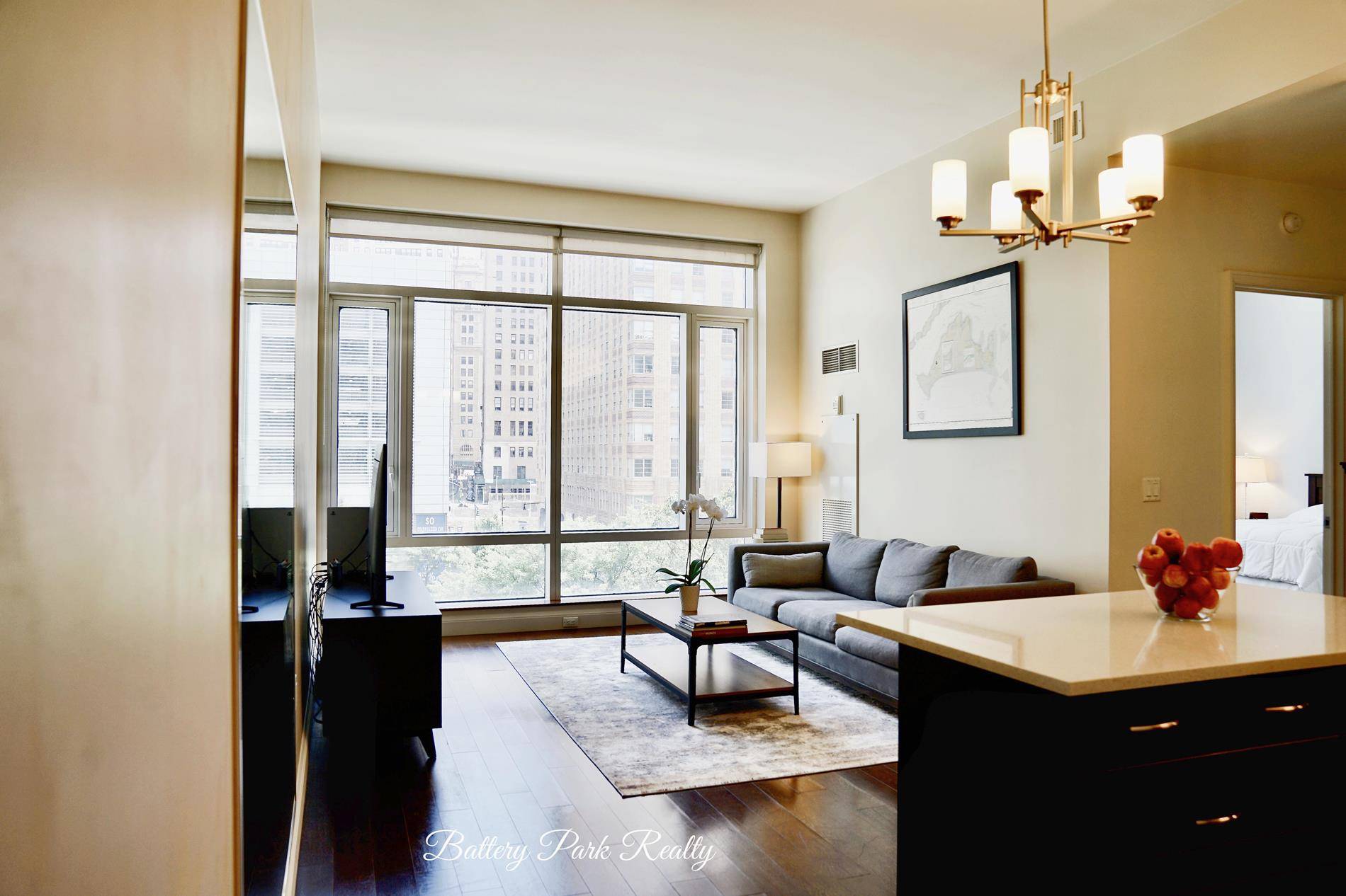 Spectacular loft like one bedroom home featuring an open floor plan, a wall of windows and perfectly situated in the heart of Battery Park City and the New Downtown.