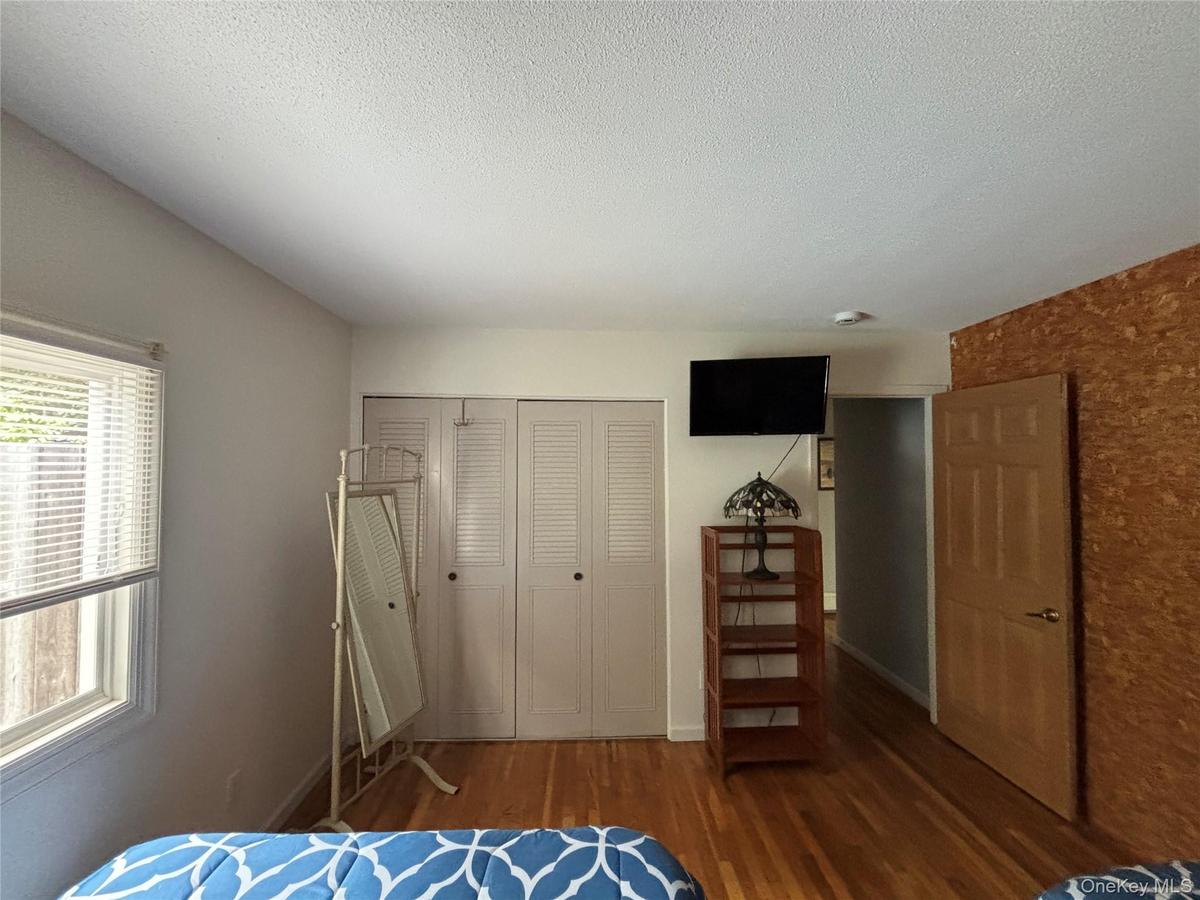 Bedroom #1Full Bed, Closet, Dresser, Mirror, Smart TV, A/C Unit