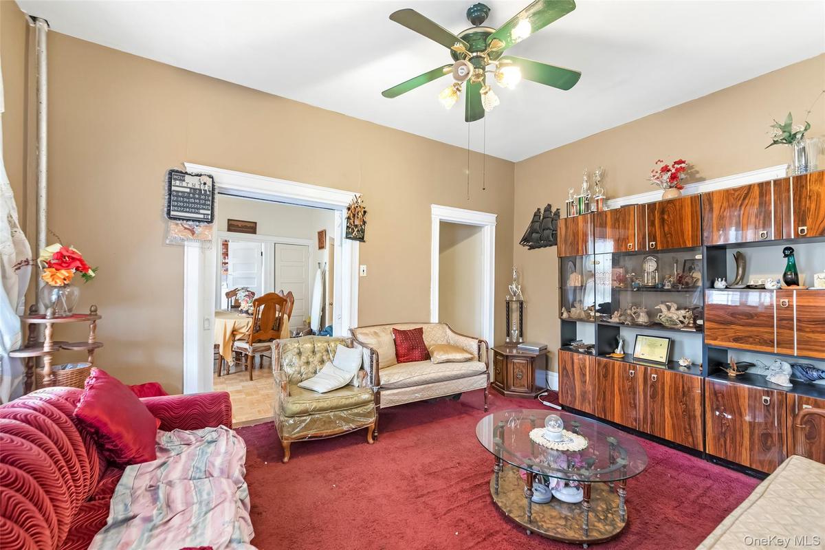 Living room with a ceiling fan and carpet floors