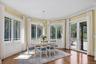 Dining area with healthy amount of natural light, dark wood-style floors, a chandelier, and ornamental molding