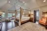 Primary suite feature soaring cathedral ceilings and private balcony