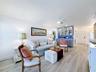 Closer look at the living room area and wet bar. Notice the tiled flooring thoughout the unit.