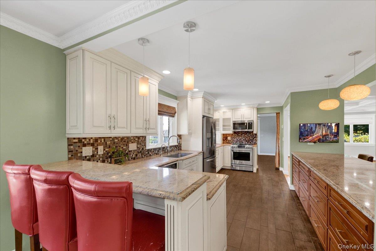 Beautiful chefs kitchen with granite countertops and stainless steel appliances.