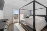 Bedroom with multiple windows, hardwood / wood-style floors, access to exterior, and ceiling fan