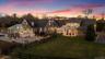 Back of property at dusk with stairs, a patio area, an outdoor fire pit, a fenced backyard, and a sunroom