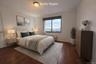 Bedroom with dark wood finished floors and baseboards