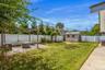 Fenced backyard with a patio area, a pergola, and a shed
