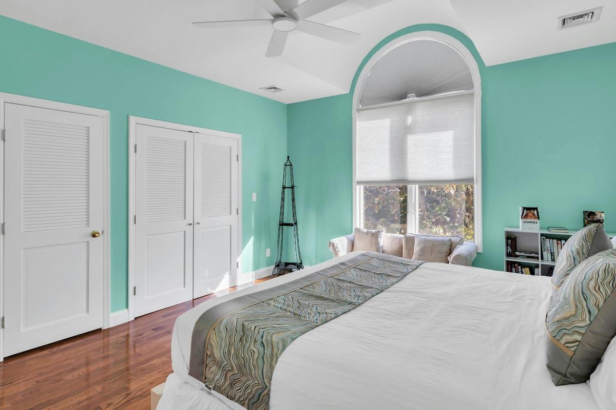 Bedroom featuring dark wood finished floors and a ceiling fan