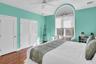 Bedroom featuring dark wood finished floors and a ceiling fan