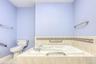 Master Bathroom with a garden tub and toilet
