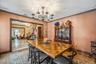 Dining area featuring a chandelier, stairs, light wood-style flooring, and ornamental molding