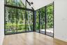 Second floor bedroom with floor to ceiling windows and outdoor access to balcony with water views