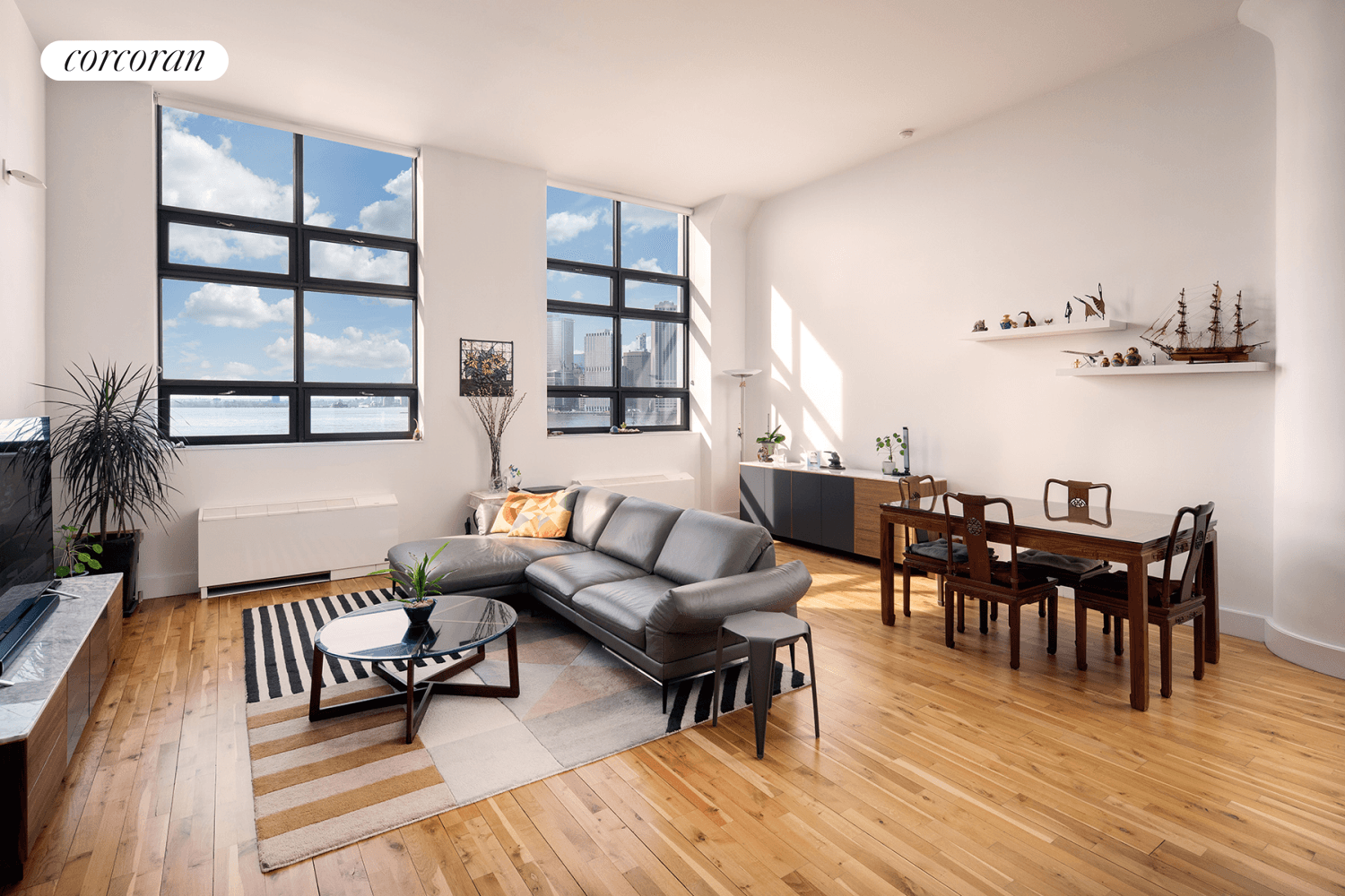 Stunning 1082 sf LOFT home office at the coveted One Brooklyn Bridge Condominium with spectacular views of the NY Harbor and Lower Manhattan Skyline.