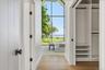 Second floor primary bedroom and walk in closet with water views