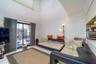 Tiled living area with crown molding and a towering ceiling