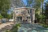 Rear view of property featuring a fenced backyard and a wooden deck