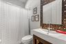 4th bedroom bath with new vanity, toilet, back splash, ,lighting and fixtures