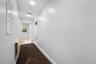 Hallway to primary bath and laundry