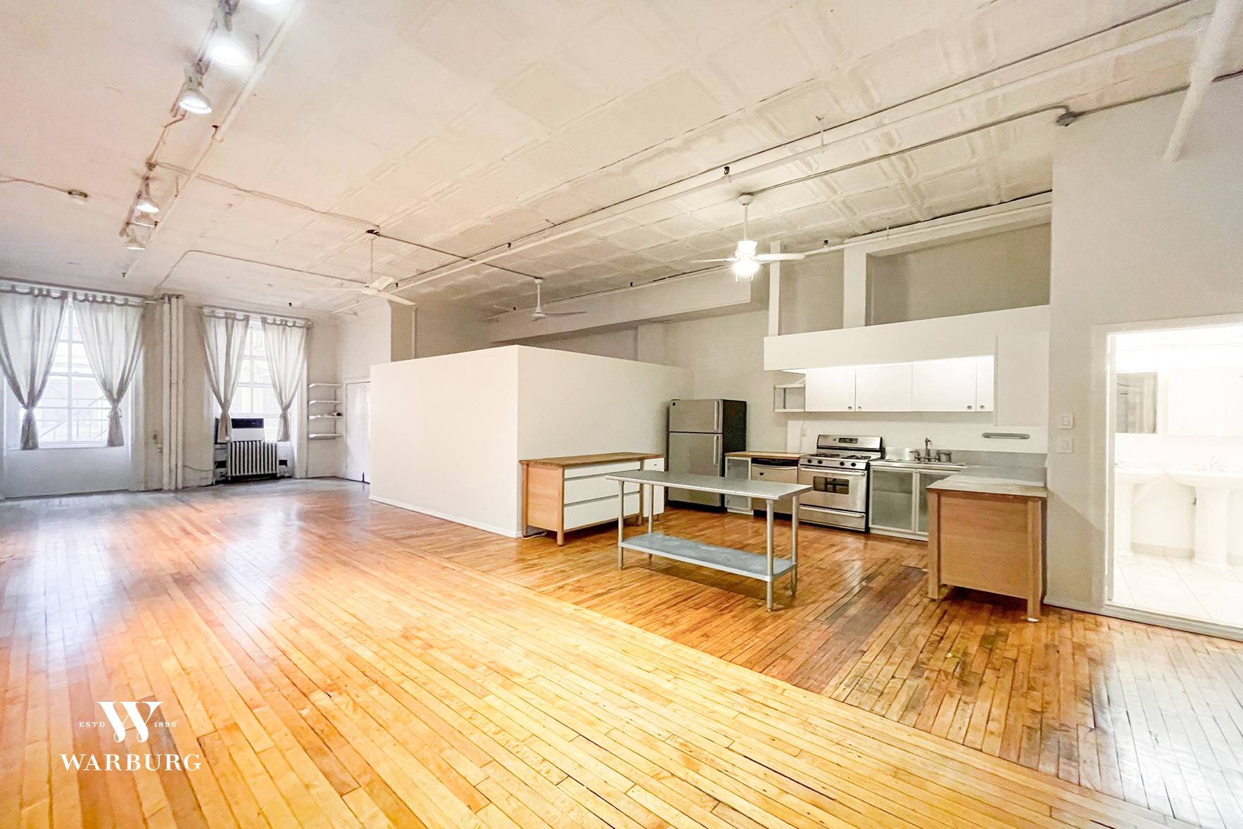 Spacious loft with home office in Prime Tribeca ;, 12 foot, high ceilings ; modern, open kitchen with dishwasher ; spacious bathroom ; wood floors, large windows with southern exposure ...