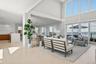 Living area featuring tile patterned floors, healthy amount of natural light, a water view, and recessed lighting