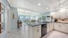 Entry into the condo and the renovated kitchen with granite countertops
