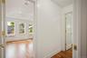 Hallway with light wood-style flooring, radiator, and recessed lighting