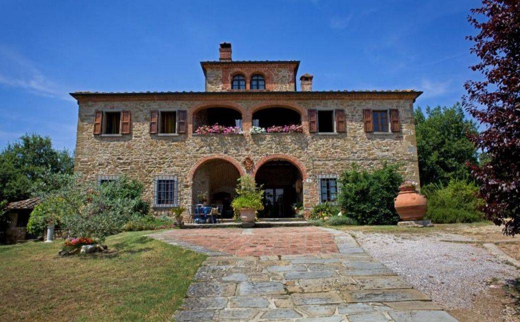 Stone country house, Leopoldina style, in elevated position in Lucignano Tuscany for sale. Swimming pool, restored stone tower, woodland and garden.
