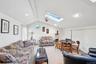 Living room featuring a skylight, carpet, and recessed lighting