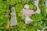 From above, the home's unique design is beautifully integrated into its lush natural surroundings.