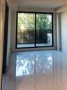 Empty room featuring healthy amount of natural light and baseboard heating