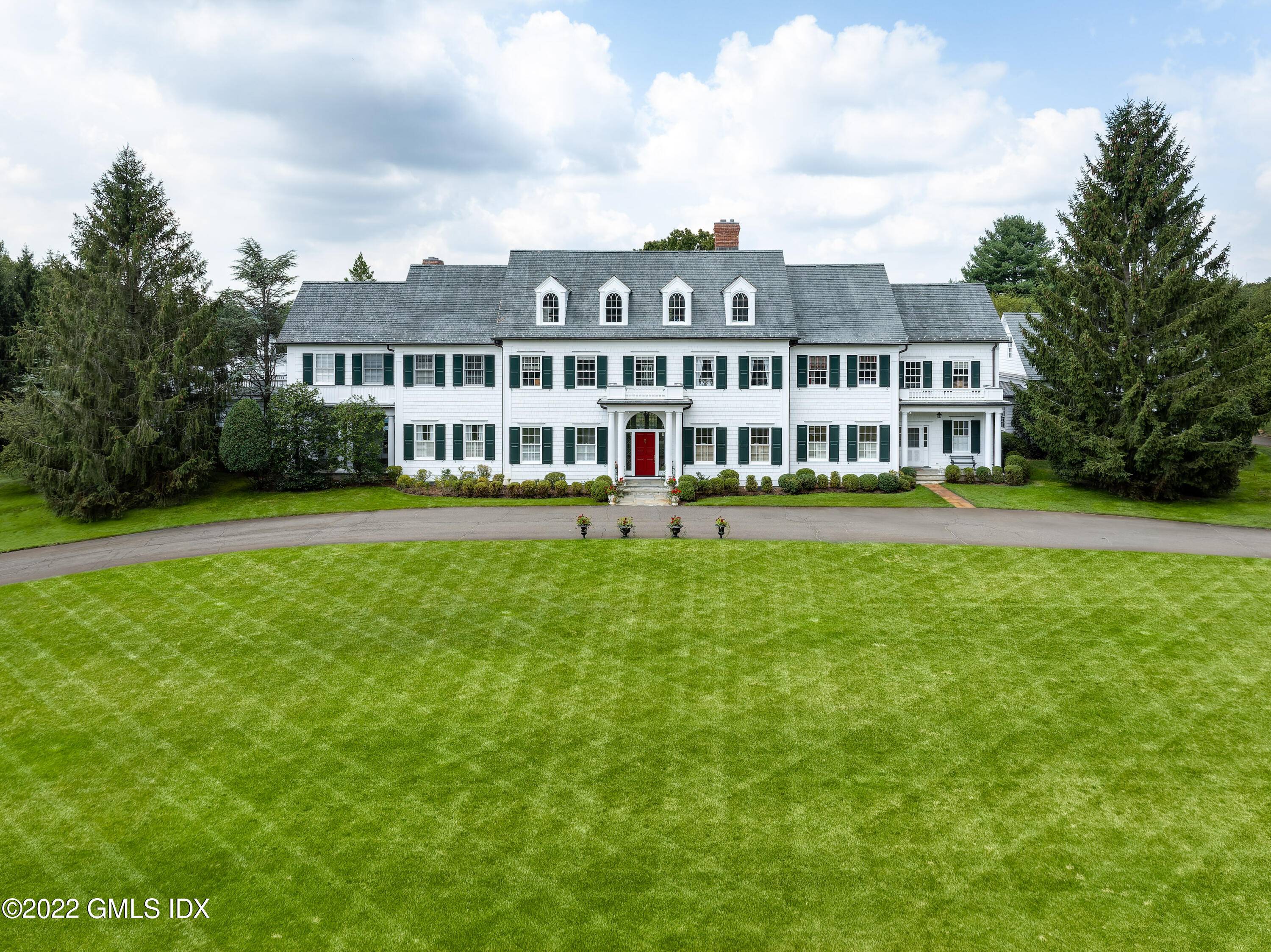 SUNNING HILL Gated Greenwich estate on 4 pastoral acres with spectacular western views in the heart of Round Hill.
