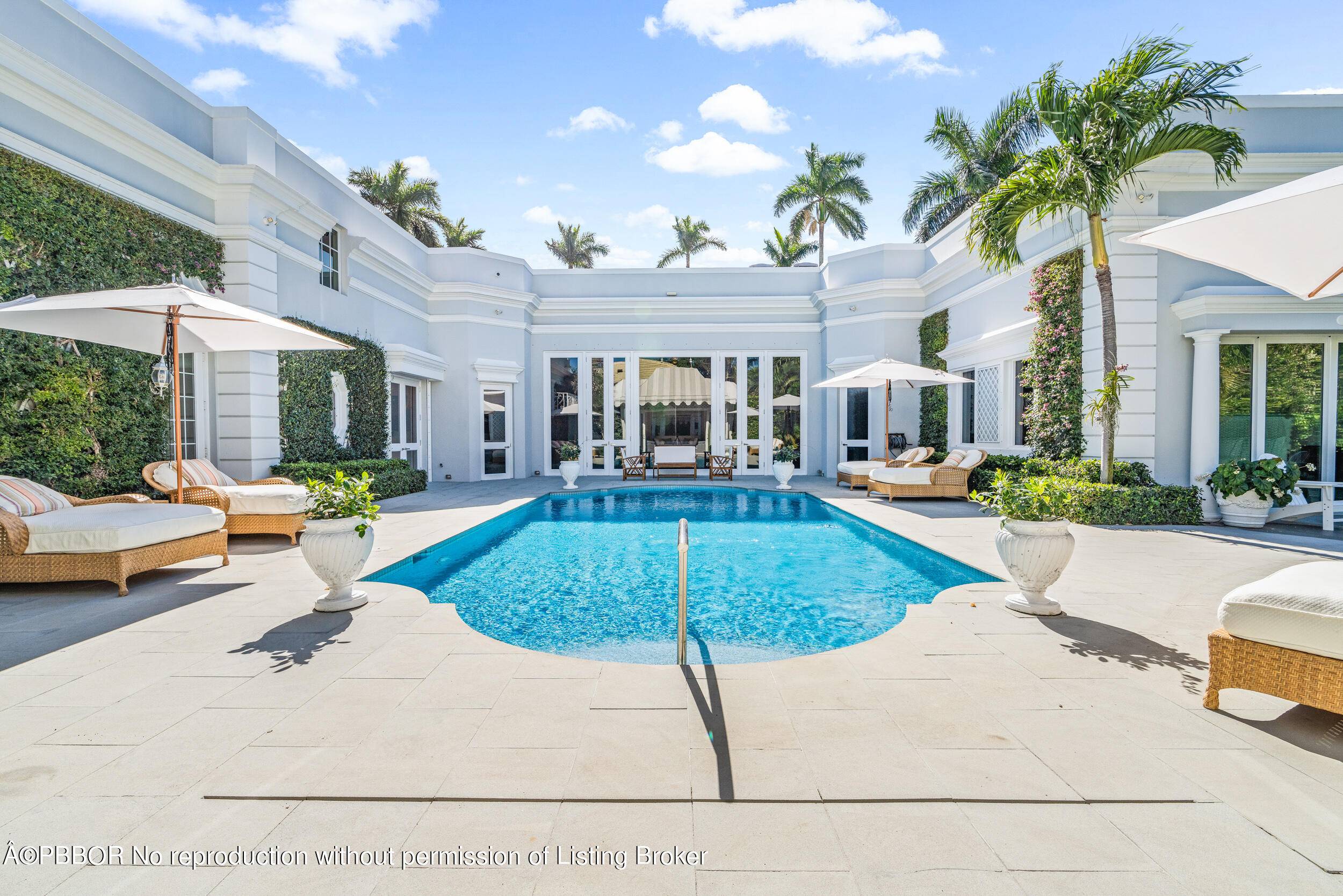 Regally elevated at 16' on over half acre this proper Palm Beach Palladian residence renovated in 2022, showcases quintessential architecture set within beautifully landscaped pool gardens.